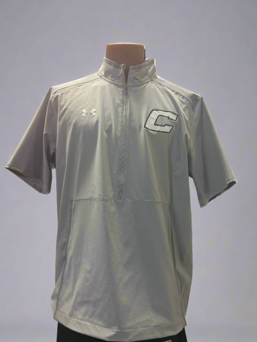 Gray sports shirt with logos on a mannequin against a gray background