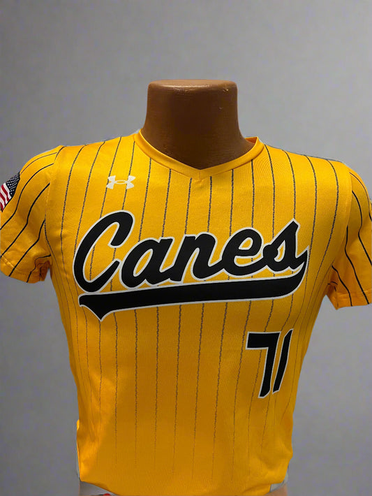 Yellow sports jersey with 'Canes' branding on a rack.